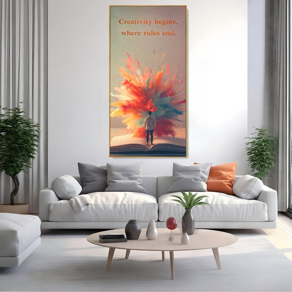 Tablou canvas cu tablou canvas cu barbat privind o explozie de culoare dintr-o carte deschisa, in rama de aluminiu auriu, pe perete intr-un living